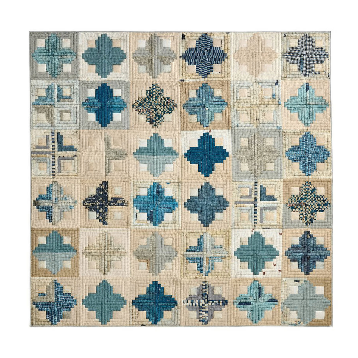 a cream and blue patchwork bedspread