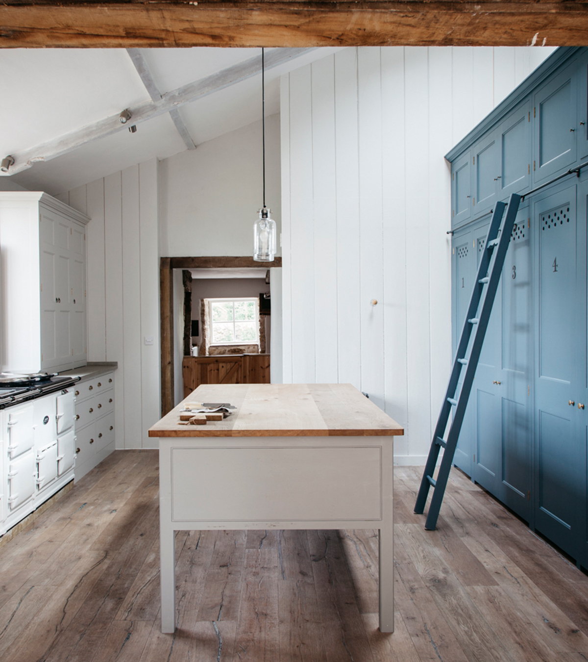plain english country kitchen with blue cupboards and ladder