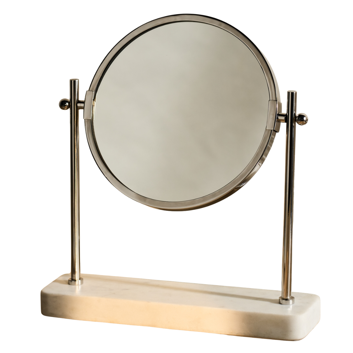 a silver round vanity mirror on a white marble stand