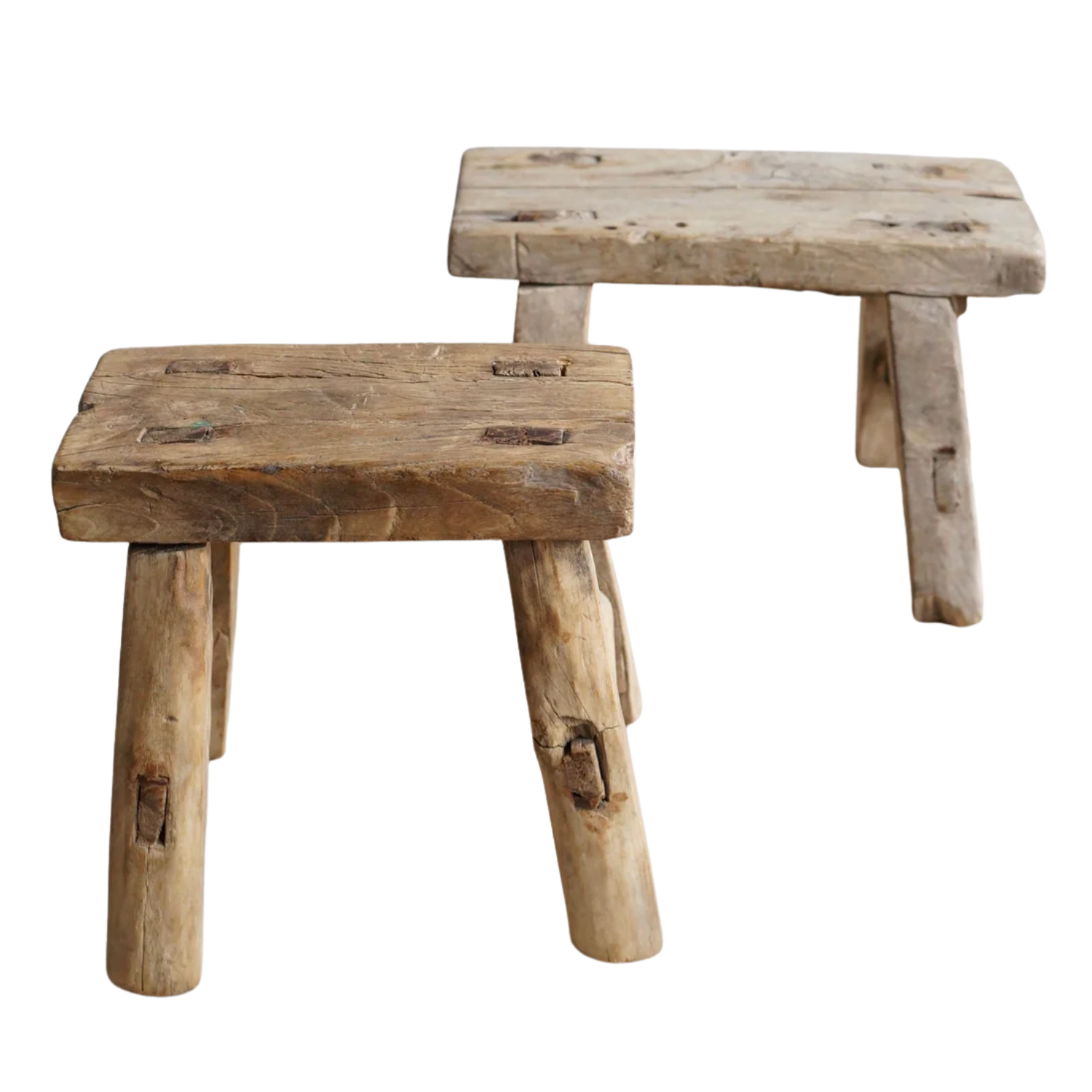 a pair of brown reclaimed wood milking stools