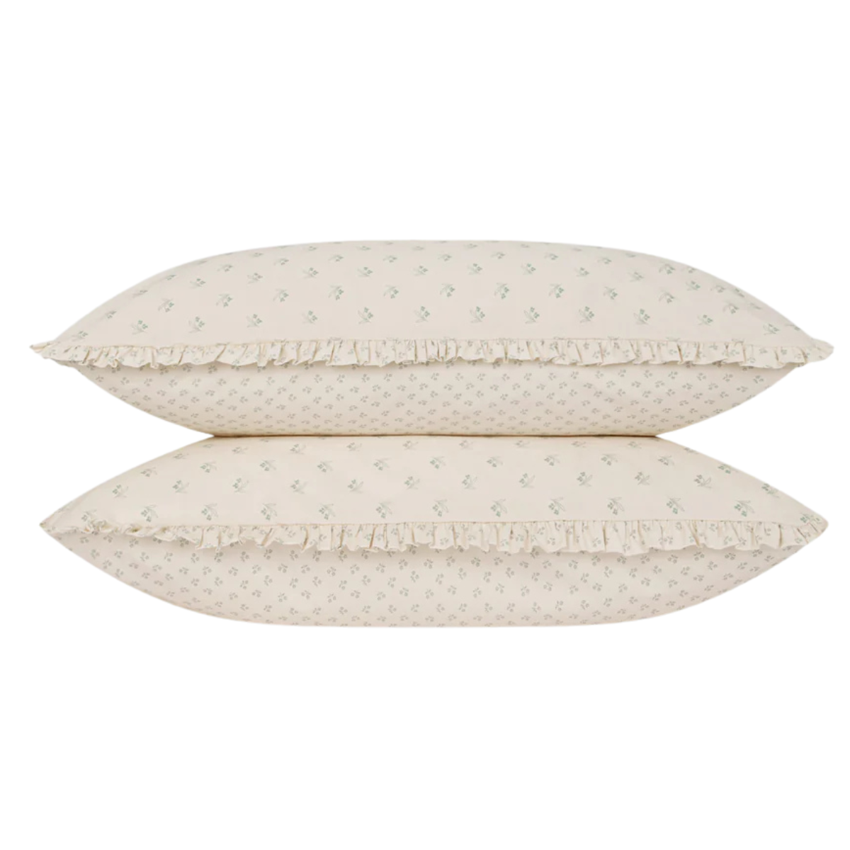 two pillows on top of each other with cream and green floral printed pillowcases with a ruffle trim