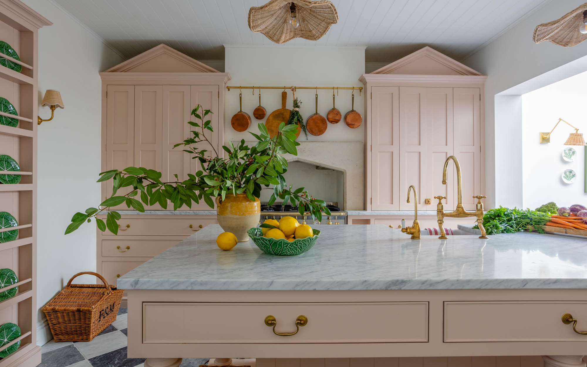 pink kitchen with green plant on kitchen island