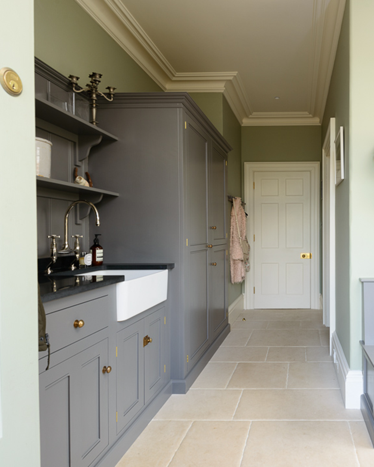 A utility room with charcoal grey cabinetry