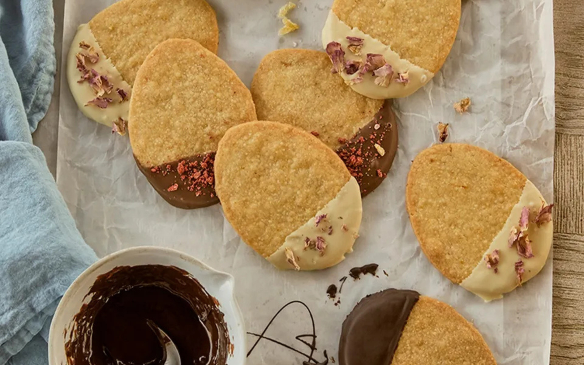 biscuits on a tray in the shape of easter eggs dipped in chocolate