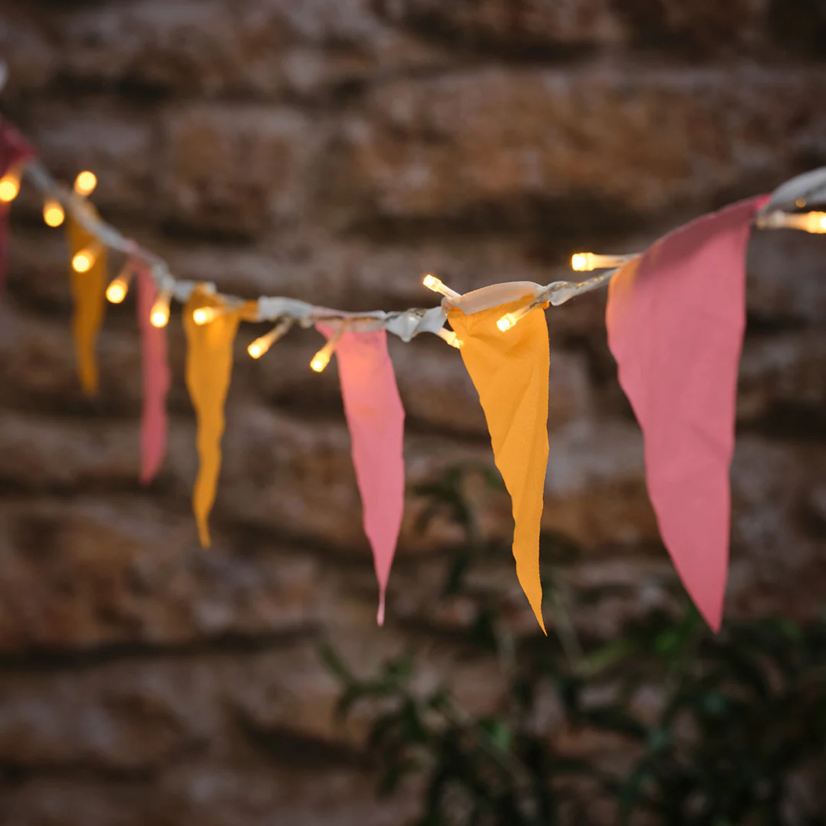 yellow and pink bunting with fairy lights