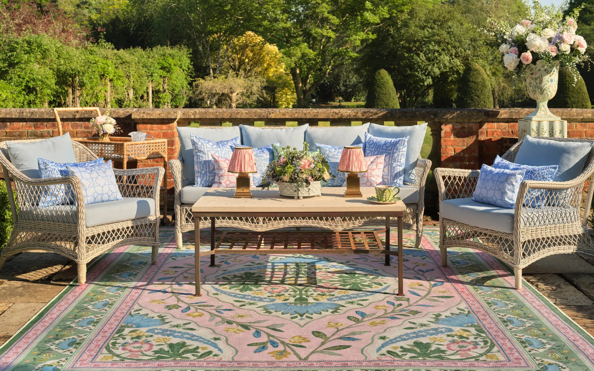 a colourful outdoor rug with rattan furniture