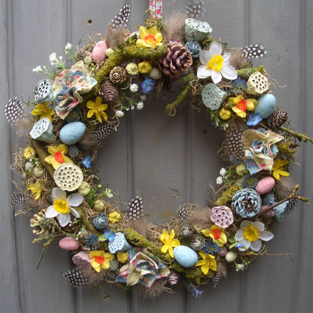 easter wreath with featehrs and eggs