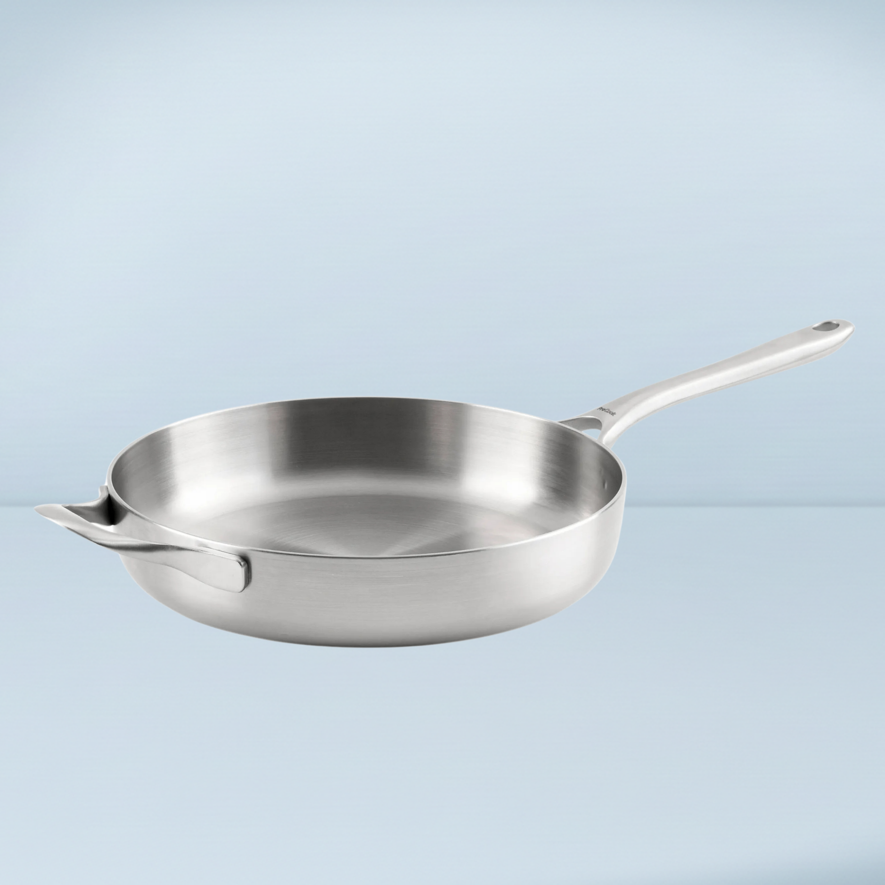 a silver frying pan with high edges