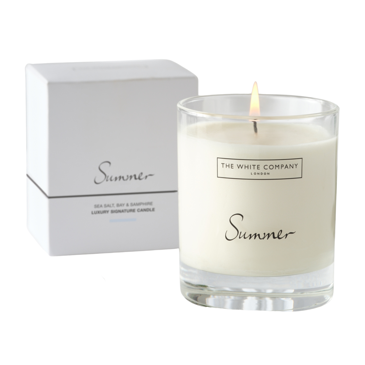 a white candle in a clear jar with the word summer on it with a white box