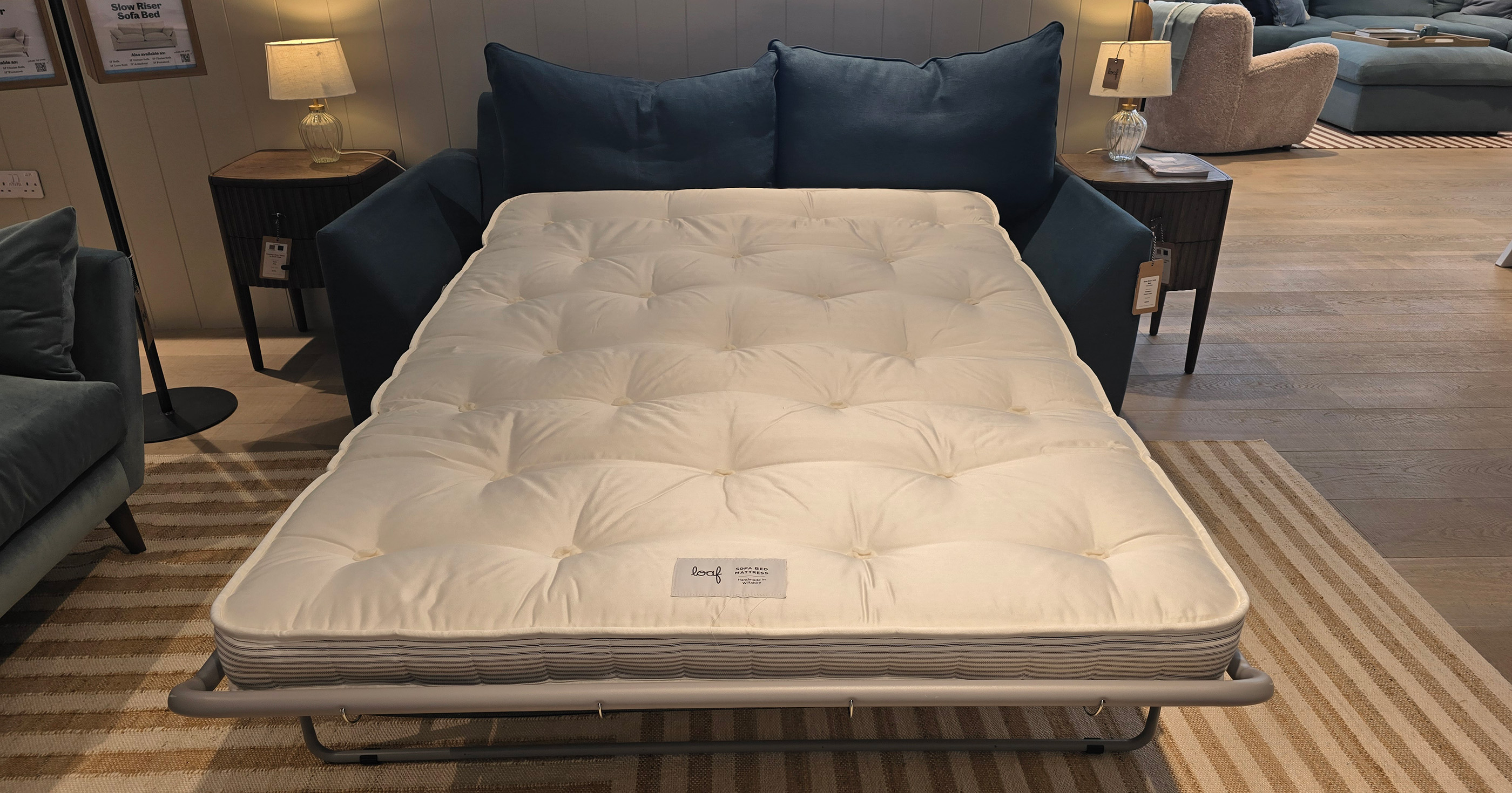 loaf sofa bed pictured with the mattress pulled out in a living room setting