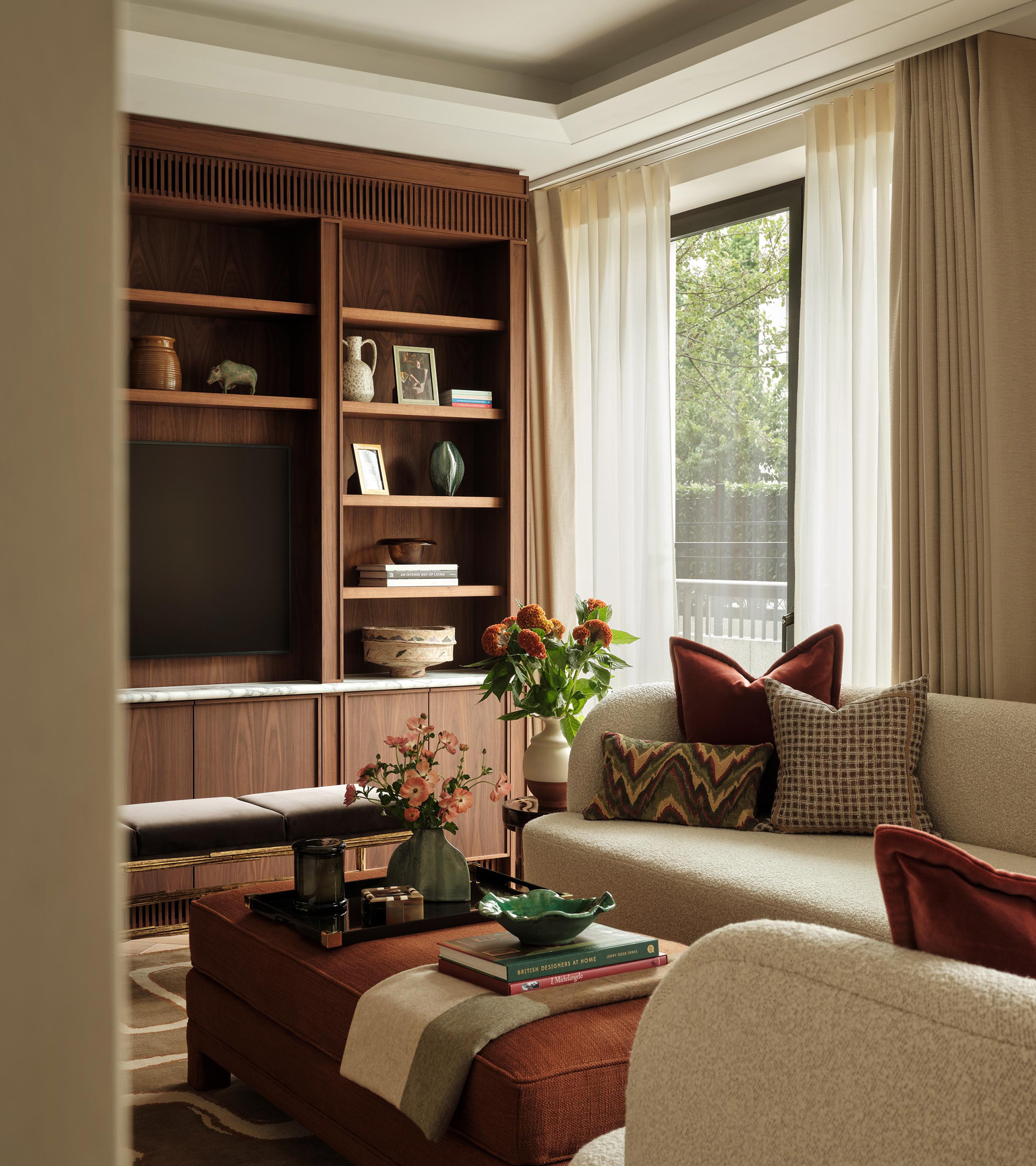 a living room with a large dark wood media unit
