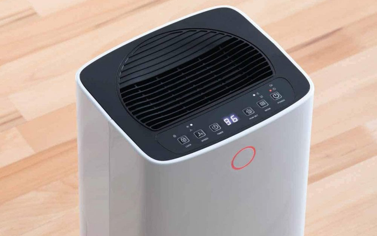the top of a white dehumidifier on a wooden floor