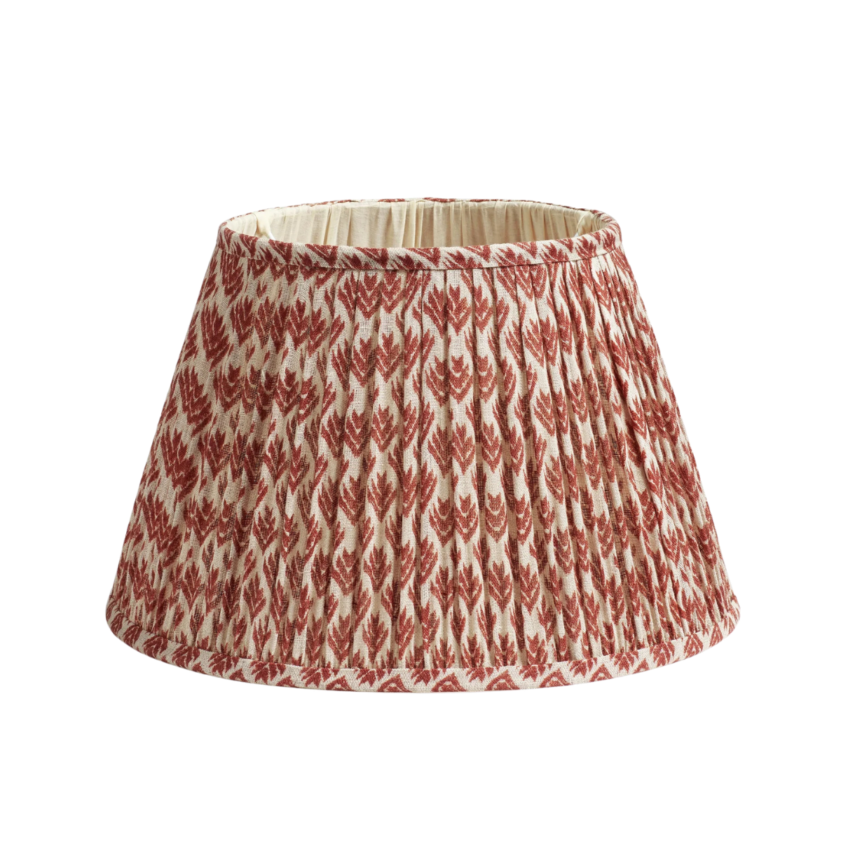 a pleated lampshade in cream and orange pattern
