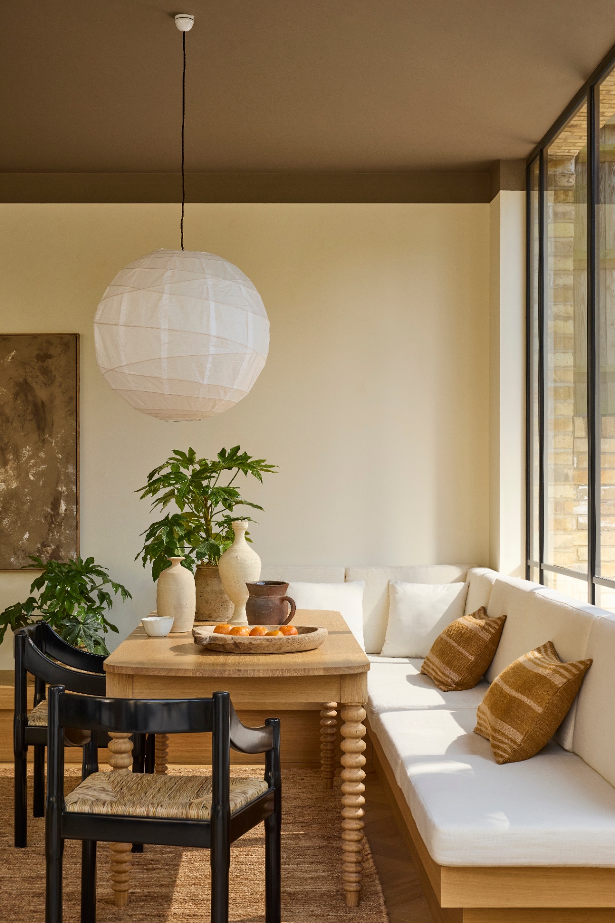 a brightly lit dining room featuring woods pictured with a sofa and window, the ceiling is painted in marle, little greenes colour of the year for 2026