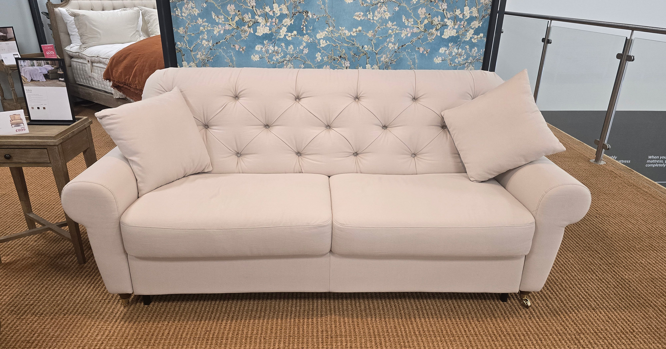 chesterfield sofa bed pictured in cream dusky pink in a living room setting