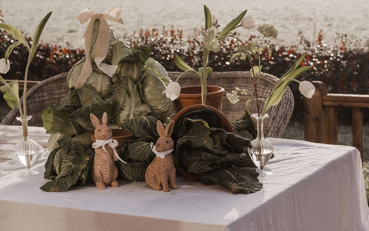 an easter table decorated with cabbage leaves