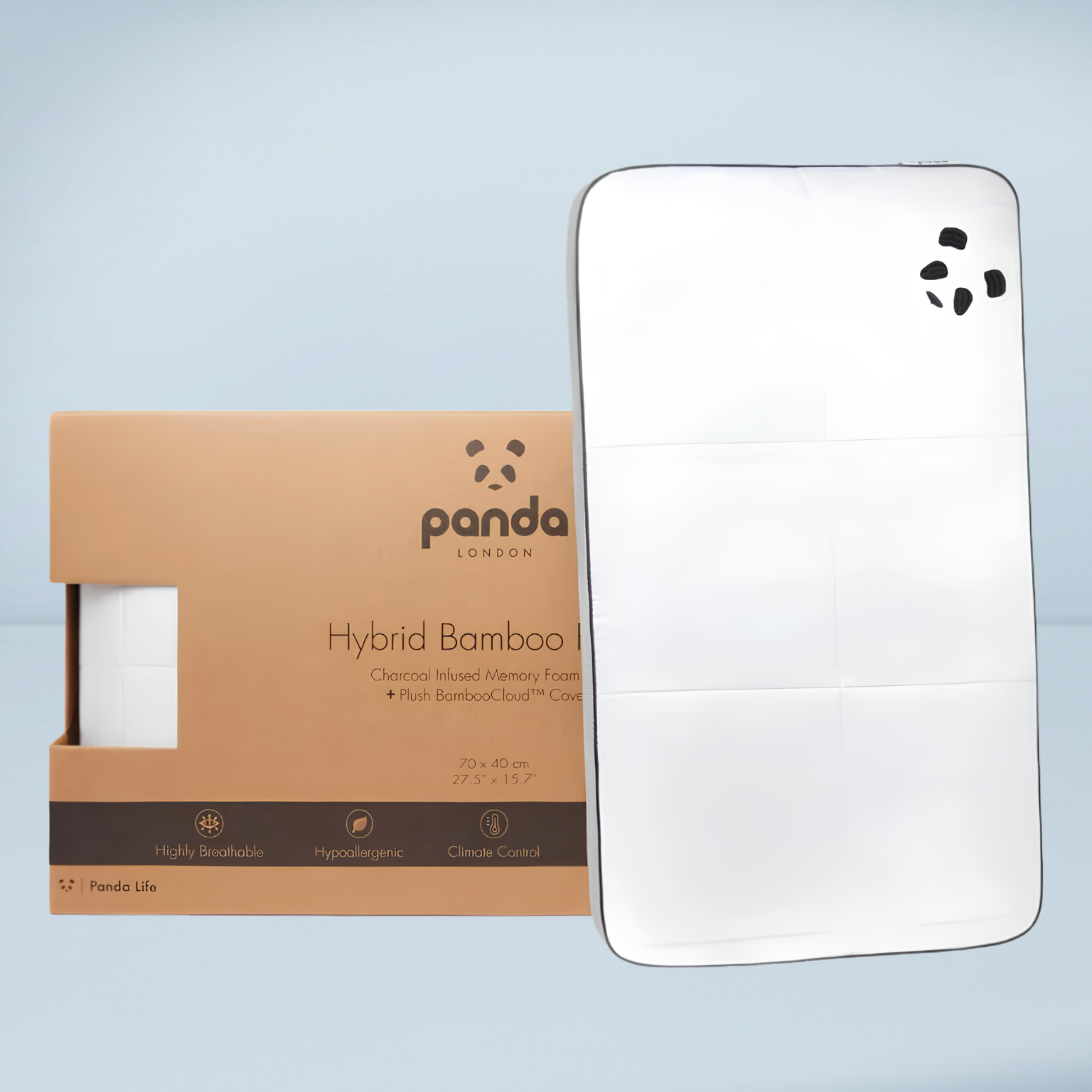 a white panda hybrid pillow next top a brown cardboard box packaging on a pale blue background