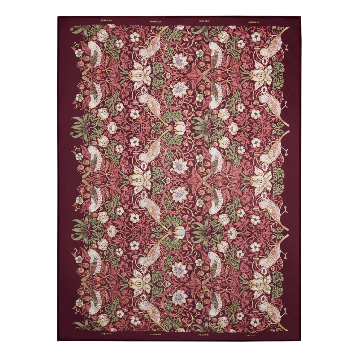a dark red velvet throw with william morris's strawberry thief print, featuring birds and botanical patterns