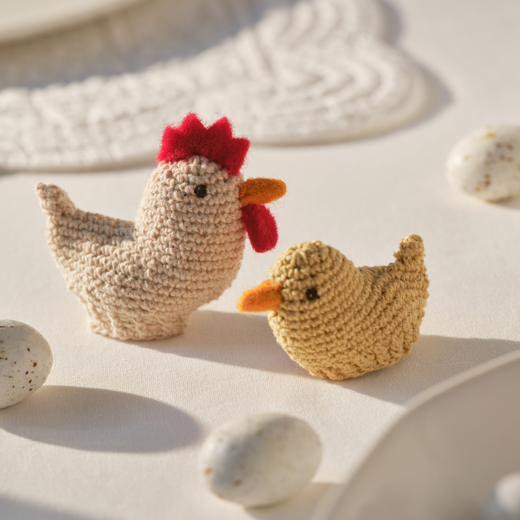 knitted egg cosy in shape of rooster and duckling