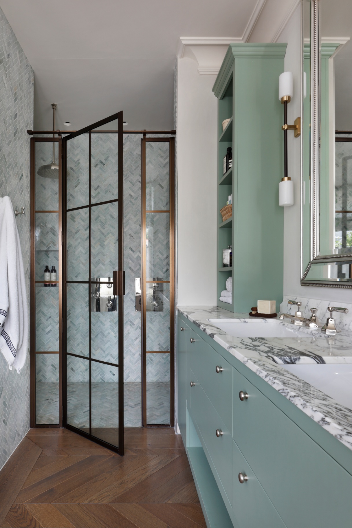 a large master bathroom pictured with a large blue vanity made of natural marble stone next to the open shower door
