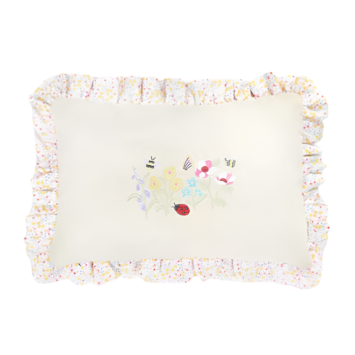 a cream cushion with flower embroidery and a floral ruffle edge