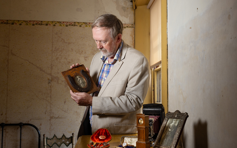 The couple's grandson, Gordon Edwards, with some of the items he donated to the house