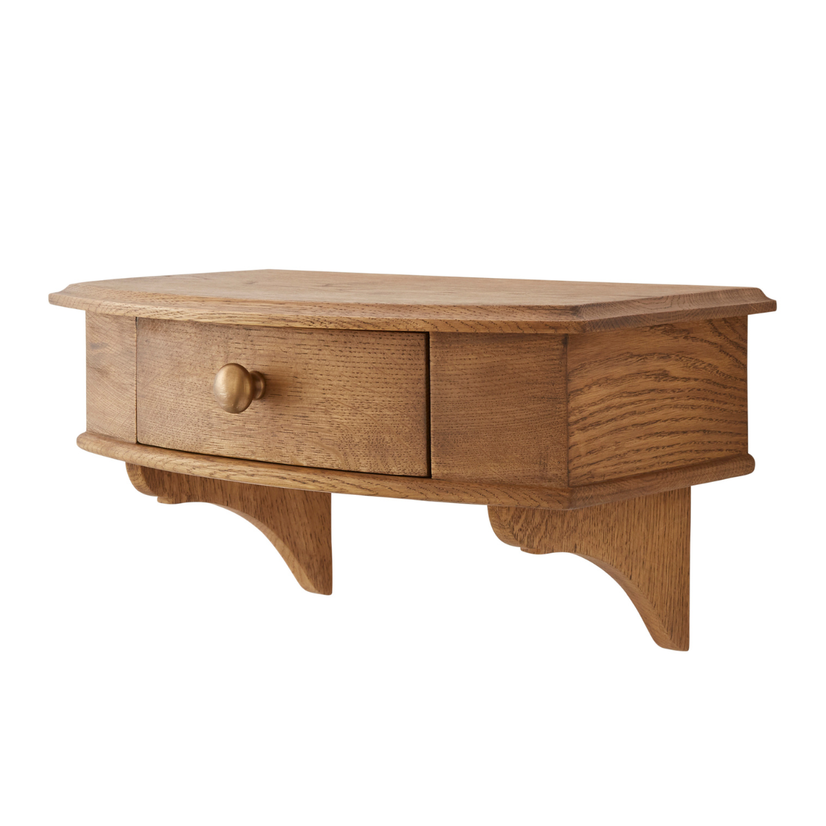 a wooden floating bedside shelf with a drawer