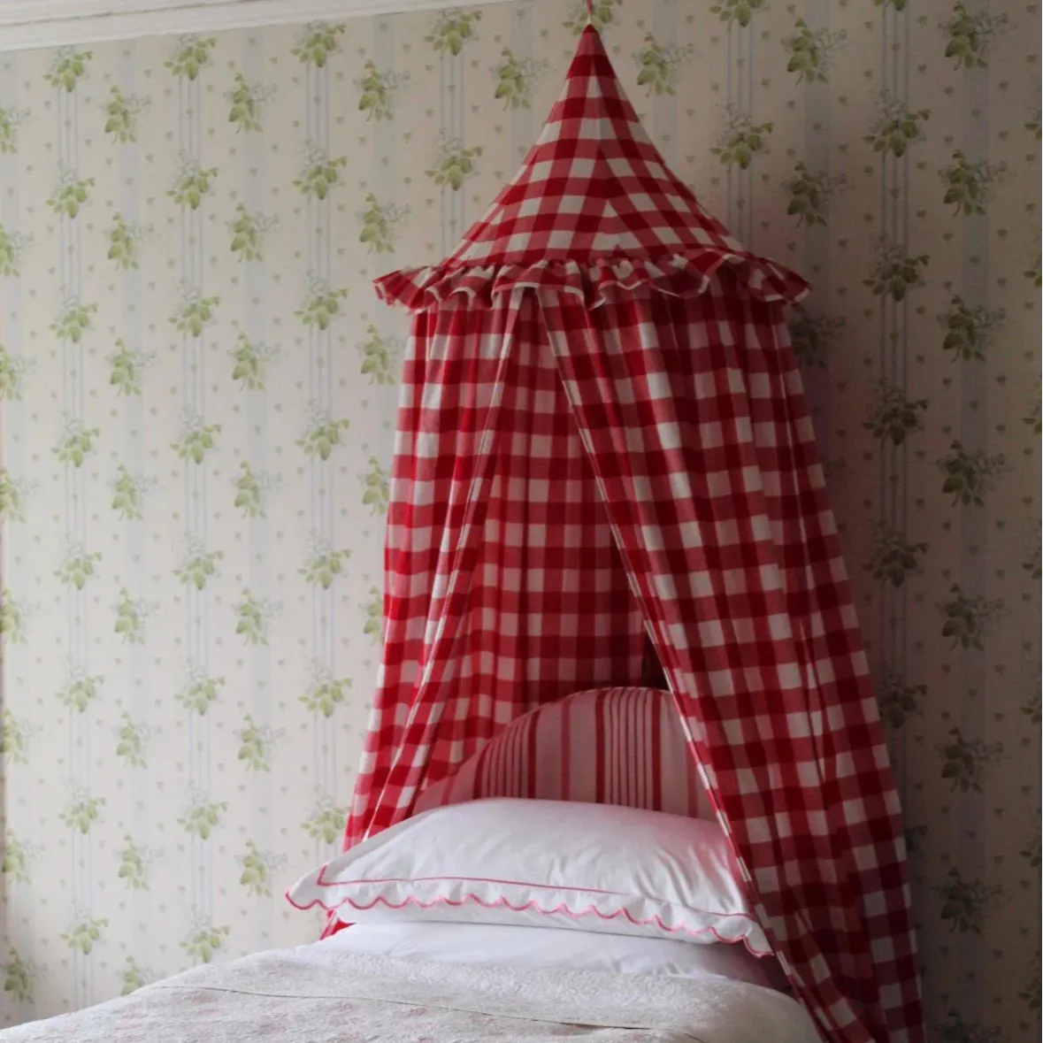 red gingham bed canopy on a single bed