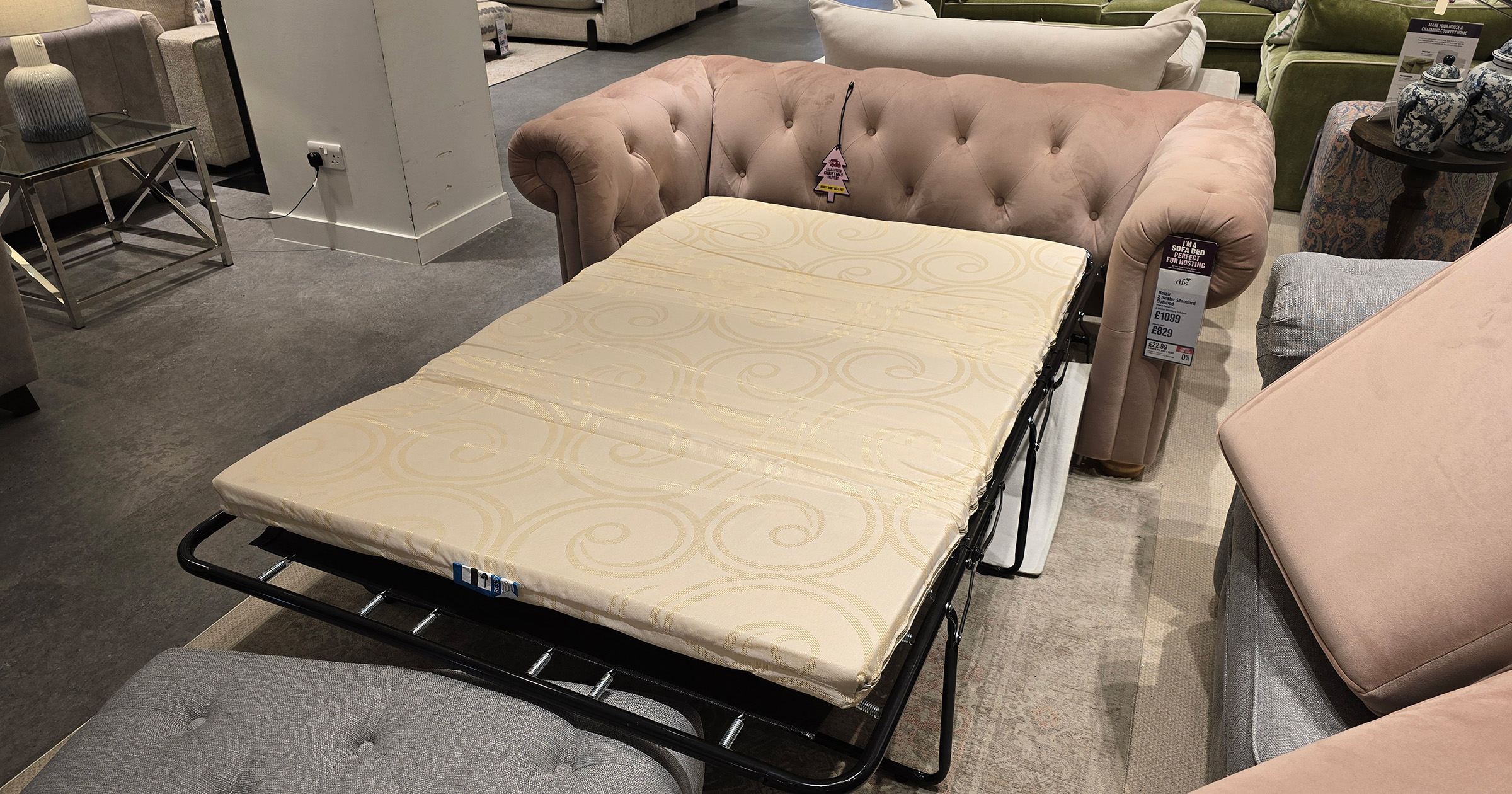 DFS Belair Sofa Bed in dusky pink pictured with the mattress pulled out on display