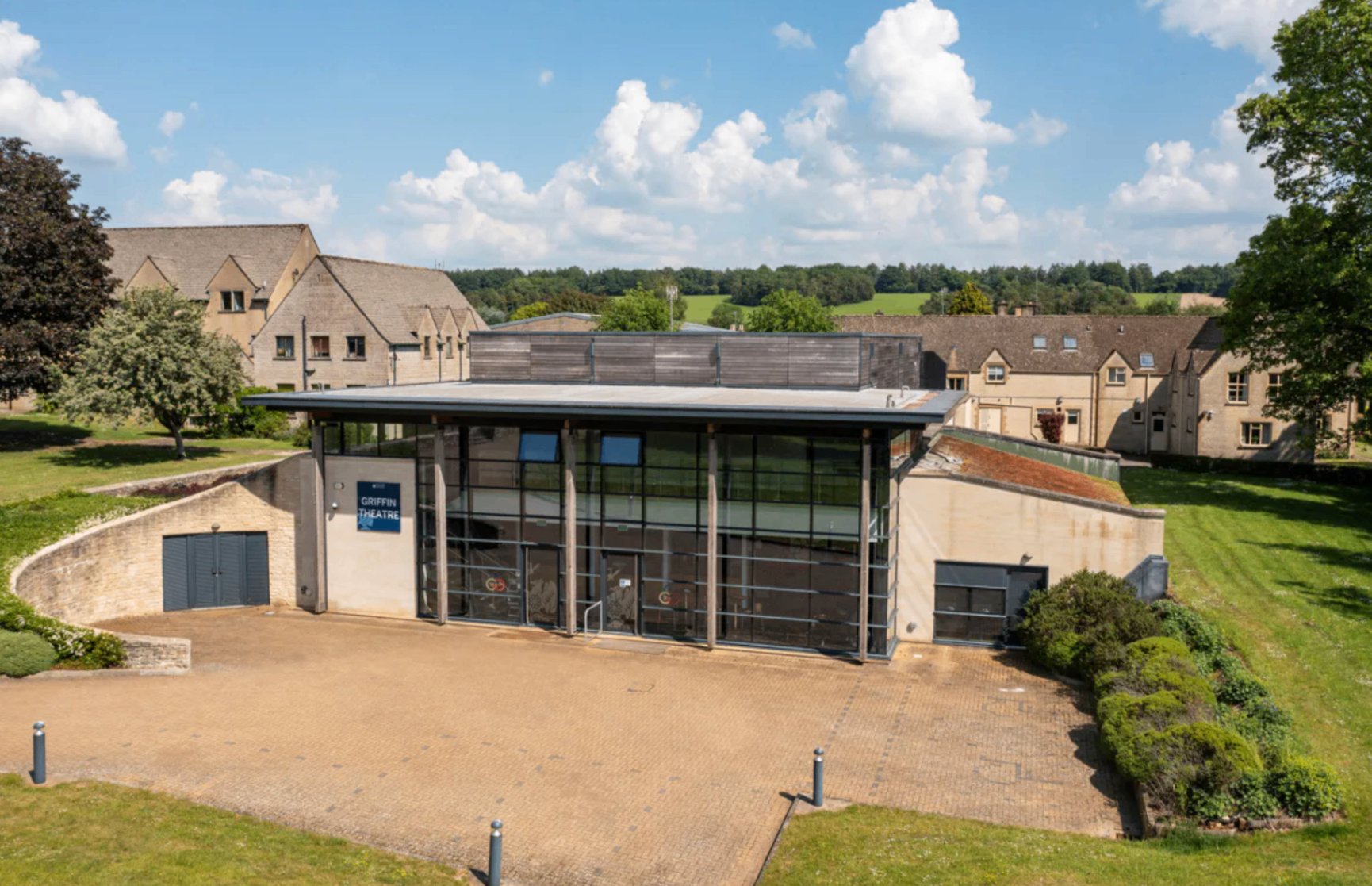 Rendcomb park estate theatre pictured with former private school outbuildings in background