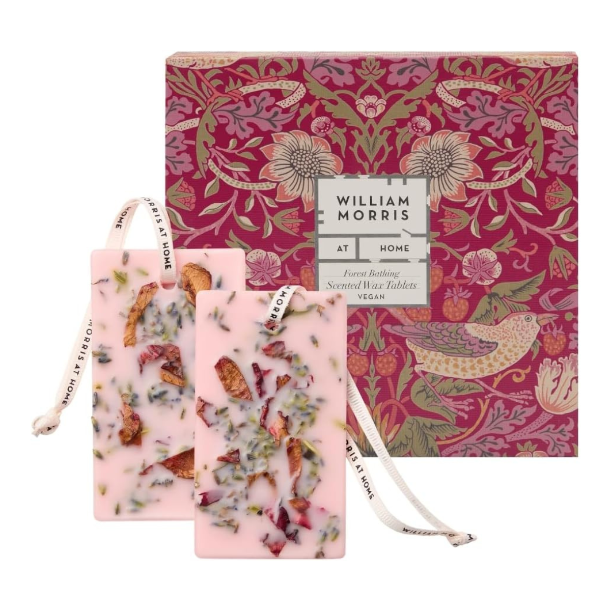 two pink wax scented tablets with petals inside in front of a pink patterned william morris box