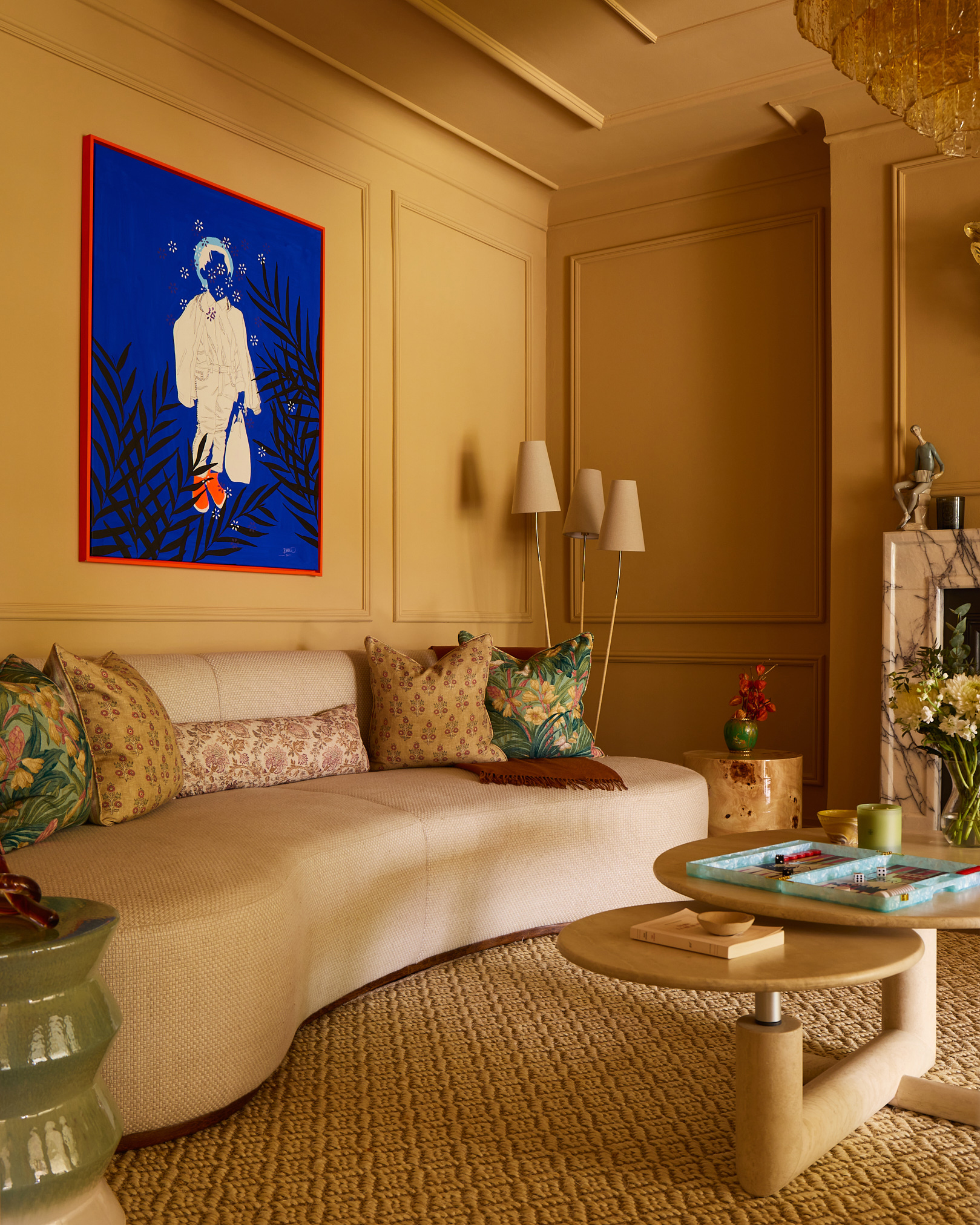 a living room with mustard yellow paneled walls and a modern cream sofa