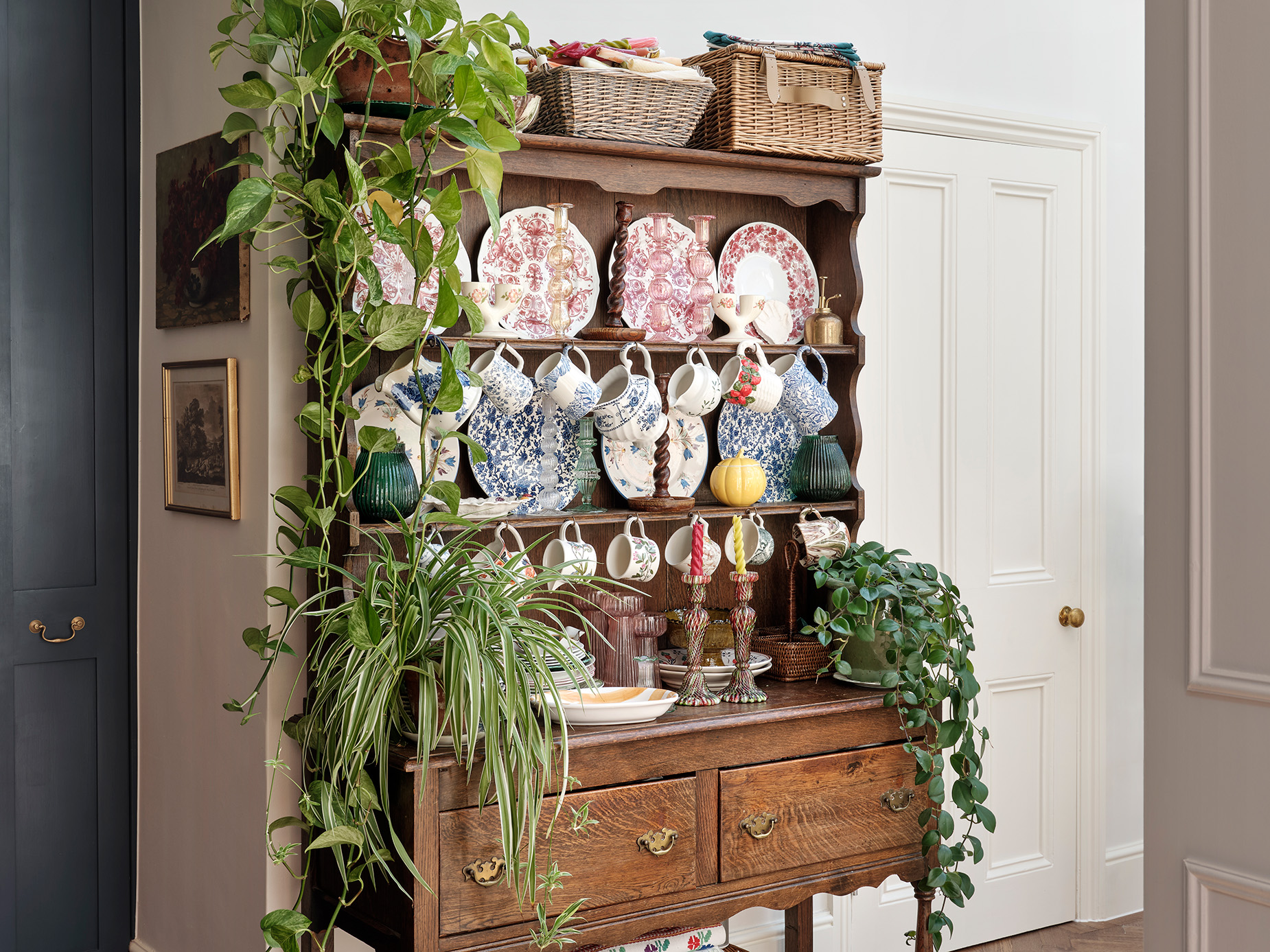 farmhouse dresser with a collection of china and plants