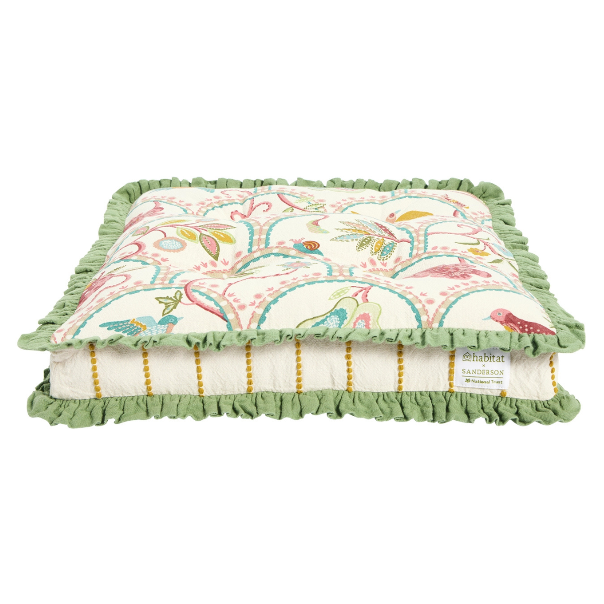 habitat x sanderson collaboration seat cushion with a cream base, a red, pink and teal pattern with birds and botanicals and a green ruffled edge
