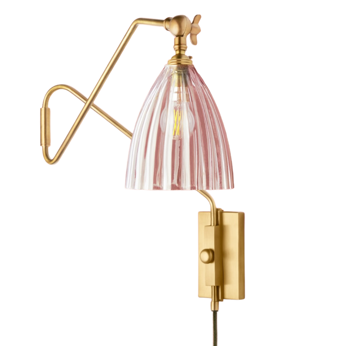 a gold wall light with a ribbed glass shade