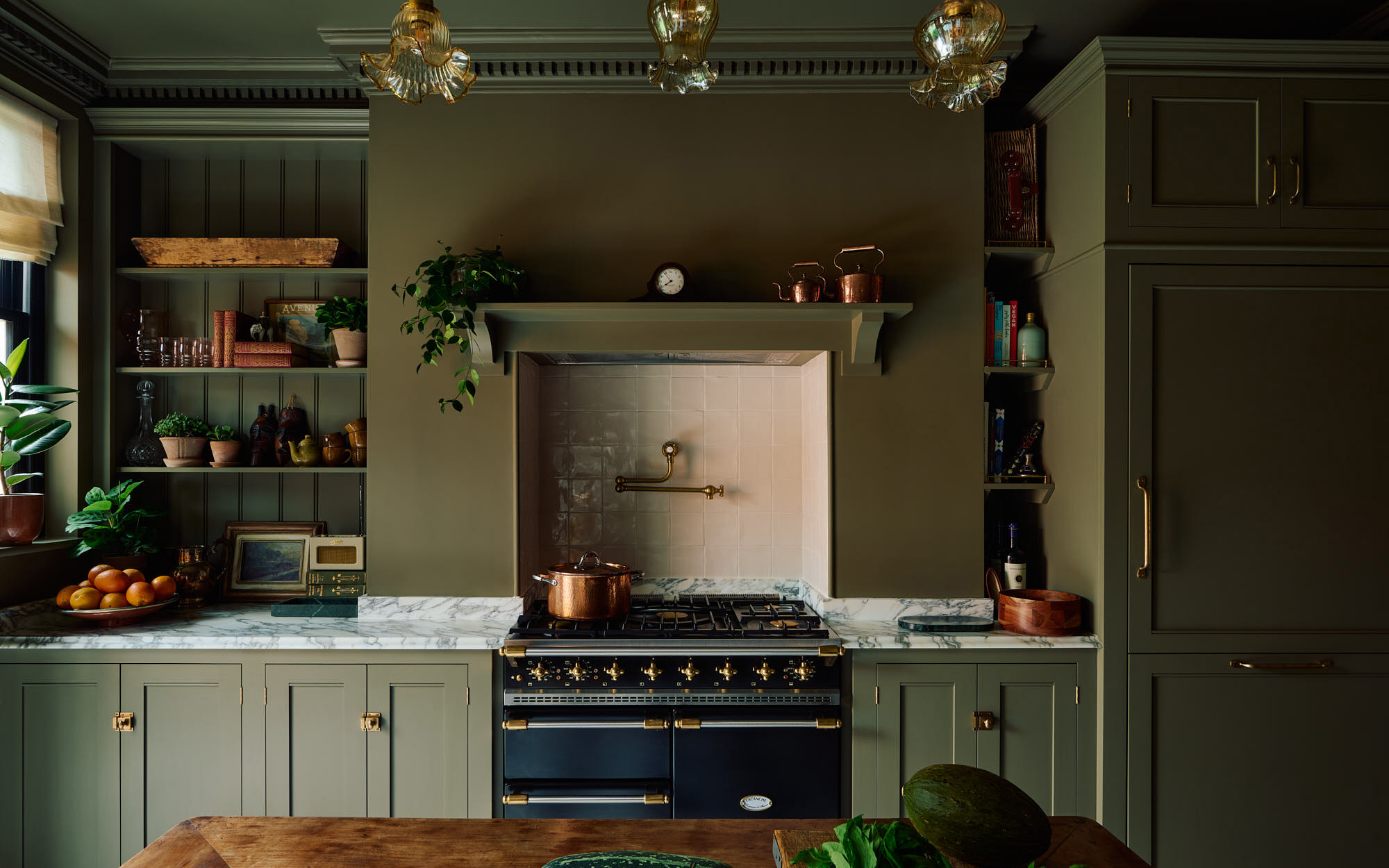 a dark olive green kitchen with a range cooker