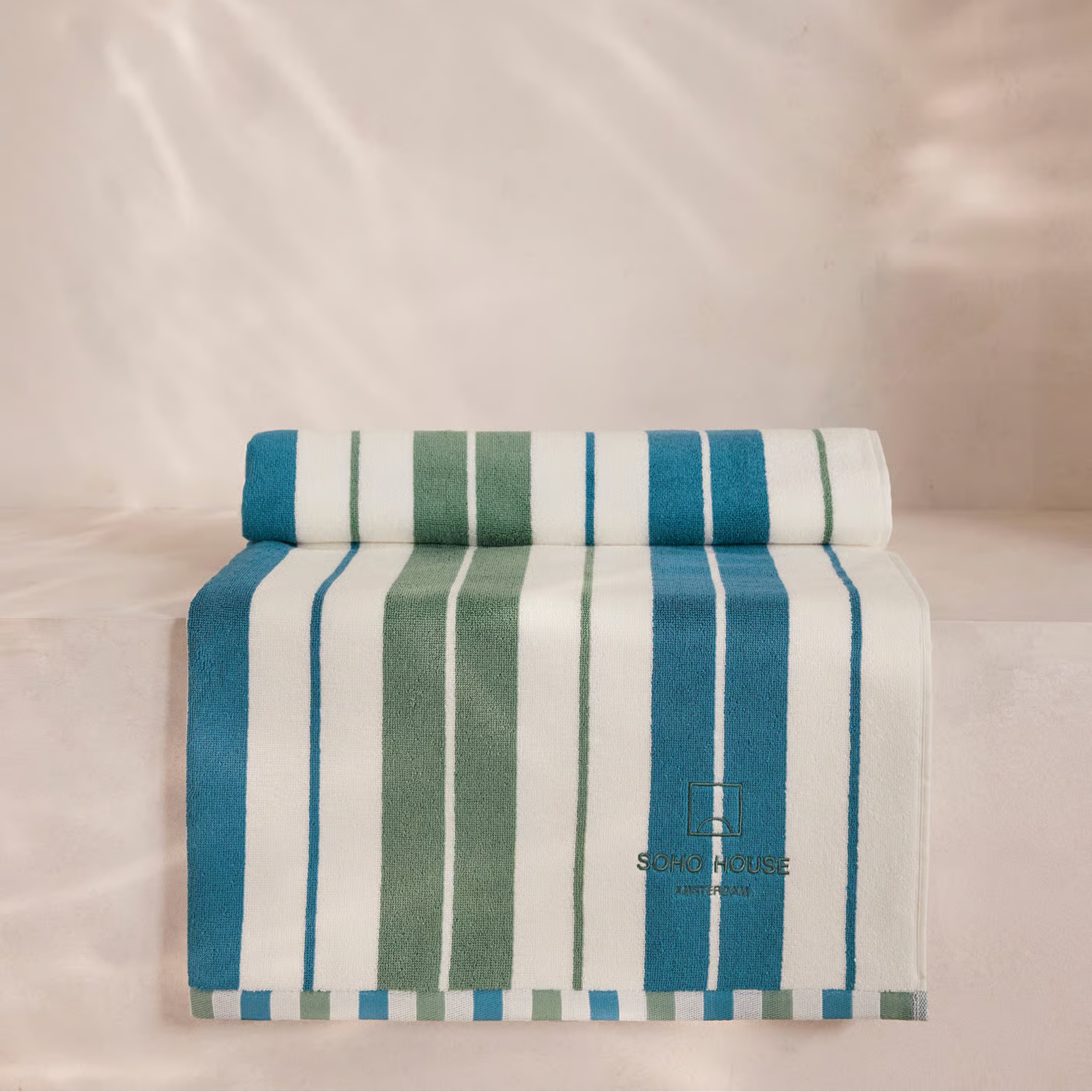 House Pool Towel, Amsterdam soho house pictured folded on a beige background