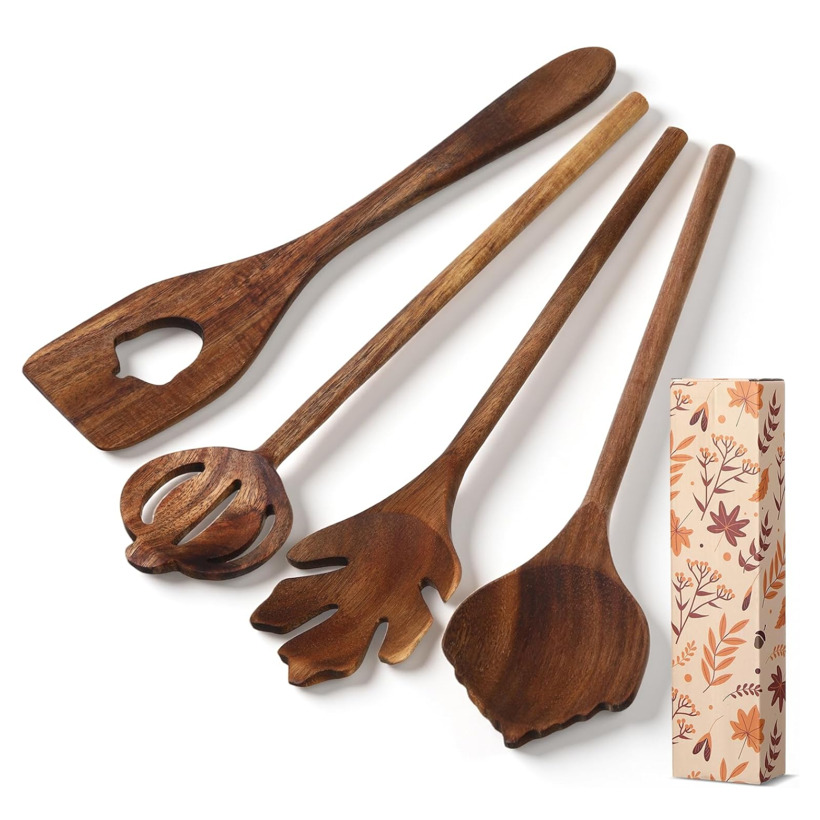 Set of four carved wooden kitchen utensils featuring autumn-inspired heads shaped like an acorn, a pumpkin, a maple leaf, and a single leaf, shown alongside a floral gift box