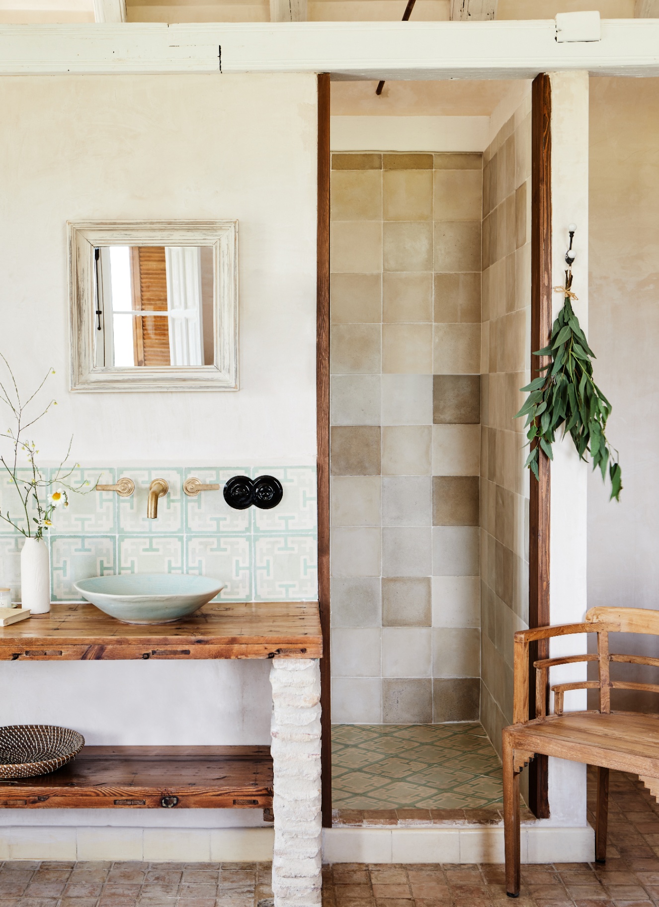 a neutral bathroom with a tiled shower cubicle, a reclaimed wood vanity with a pale green basin and splashback and a small white mirror above it