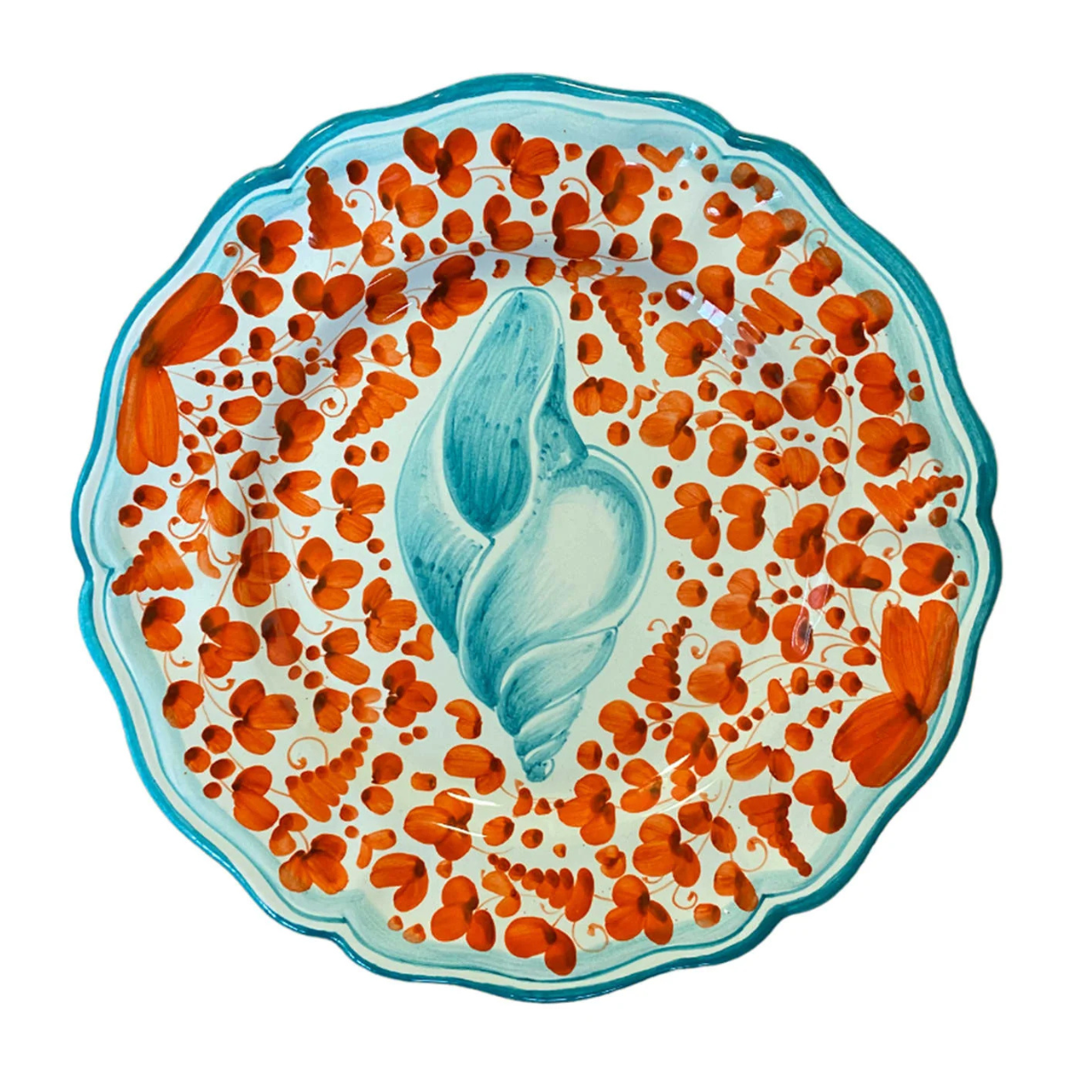 a blue and red plate with a sea shell illustration and a wavy edge