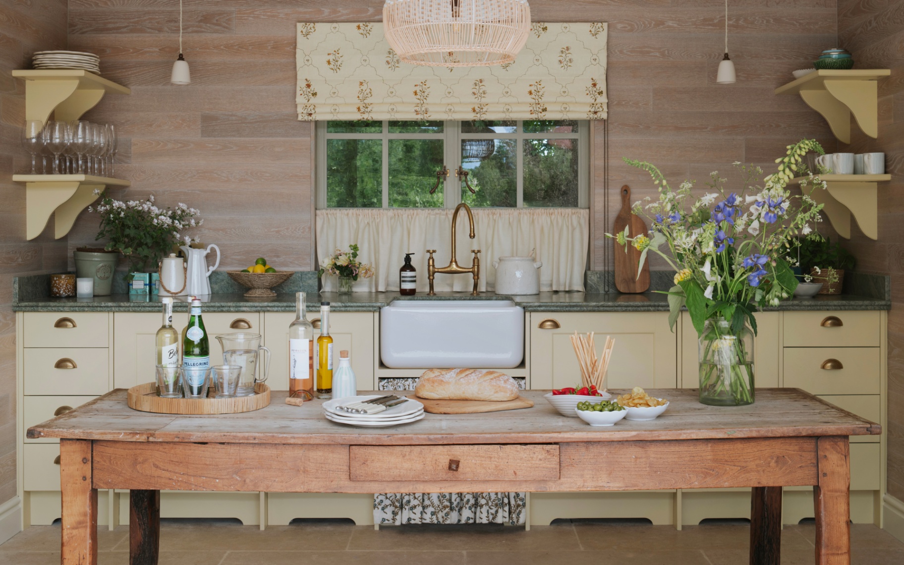 wooden pool house pictured with timber accents and panelling with a belfast sink and table