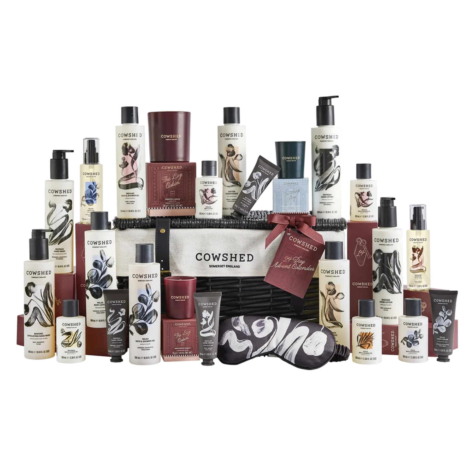 Cowshed advent calendar featuring a woven dark wicker hamper overflowing with various bath, body, and skincare products