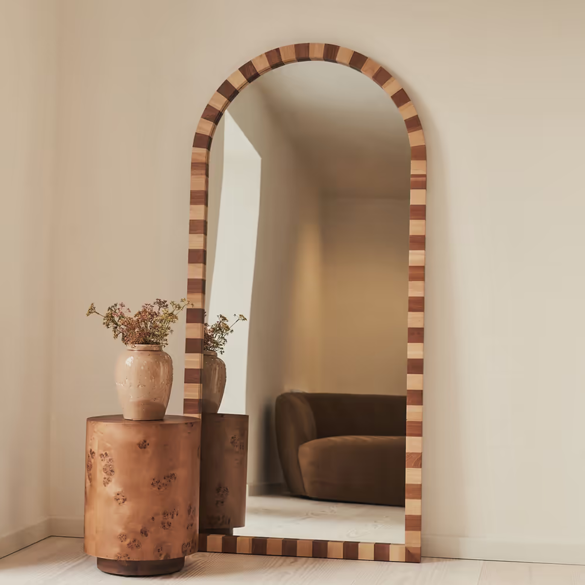 brown checkered wood full length mirror leaning on a wall with a potted plant in front of it