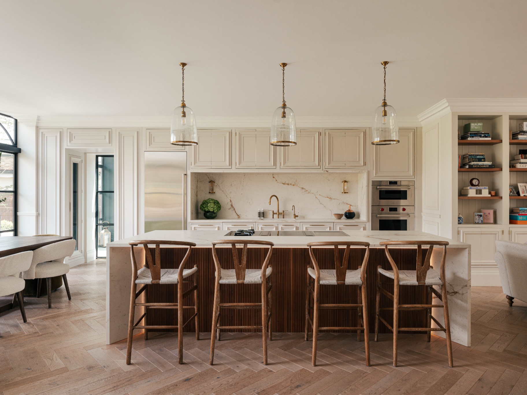 Gavid Gandys bespoke kitchen island designed by Bakehouse Kitchens above it hang large pendant lights by Pooky All the kitchen appliances are Sub-Zero & Wolf 