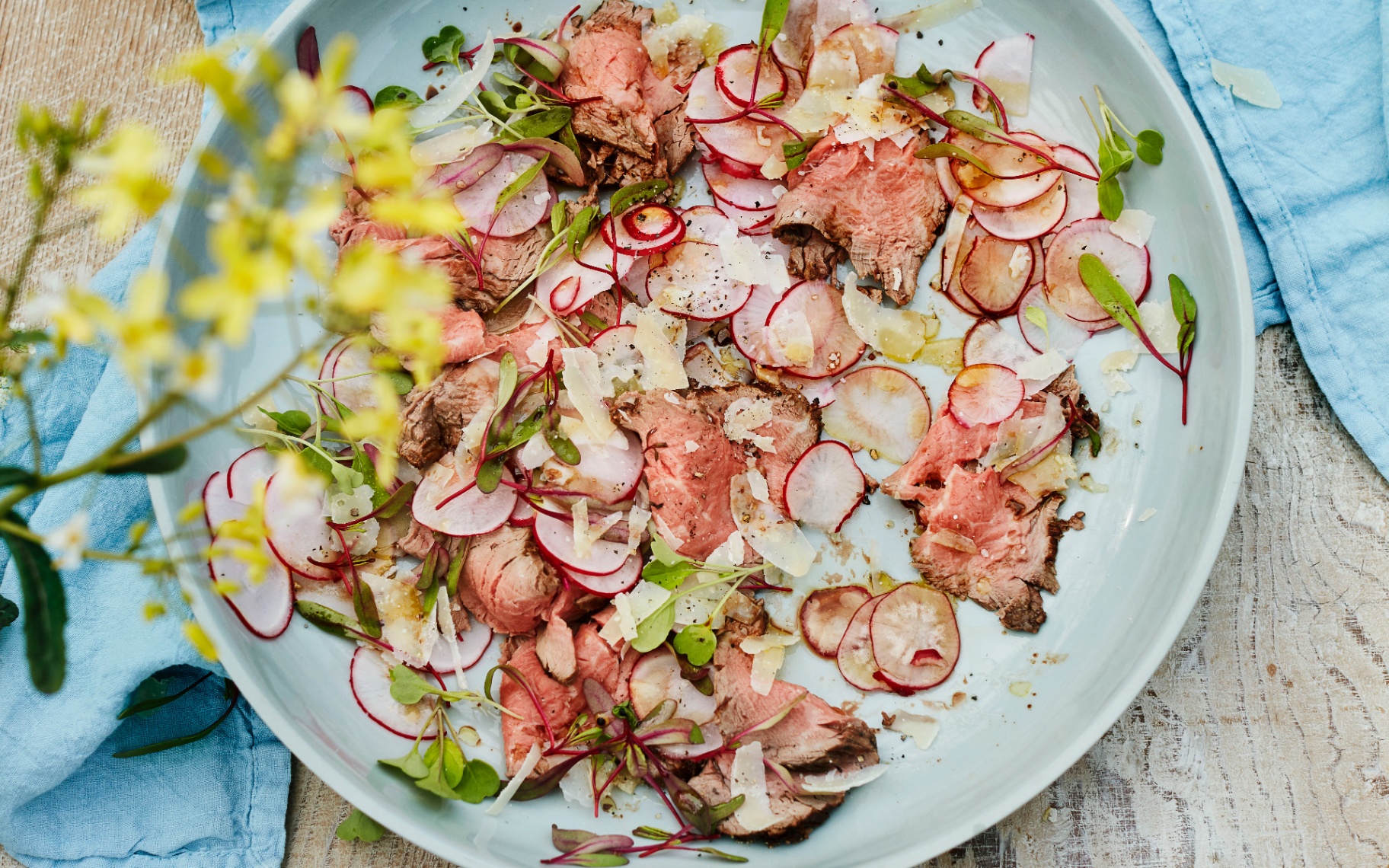 Barbecued Fillet of Beef with radishes on a white plate