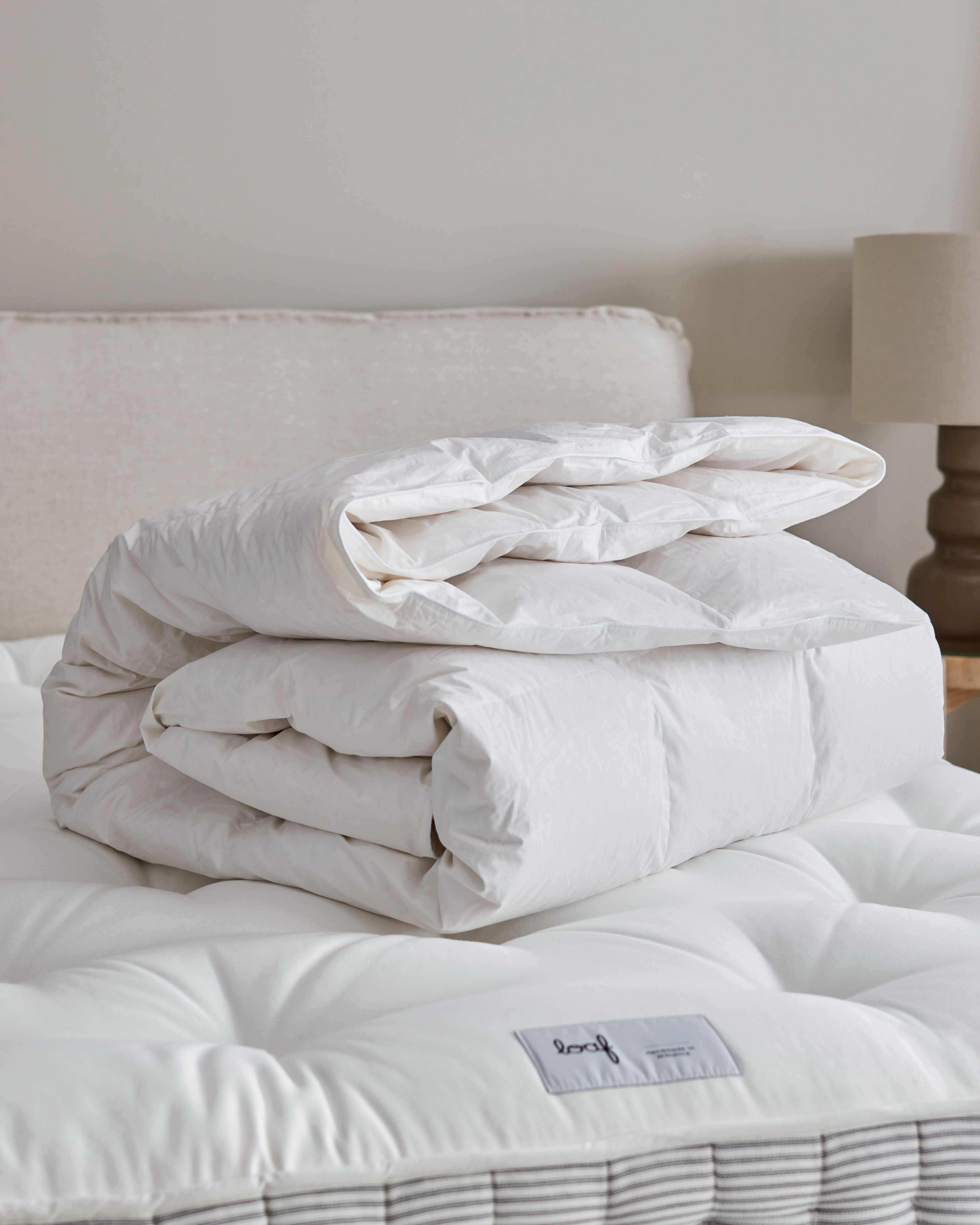 a duvet folded on a mattress