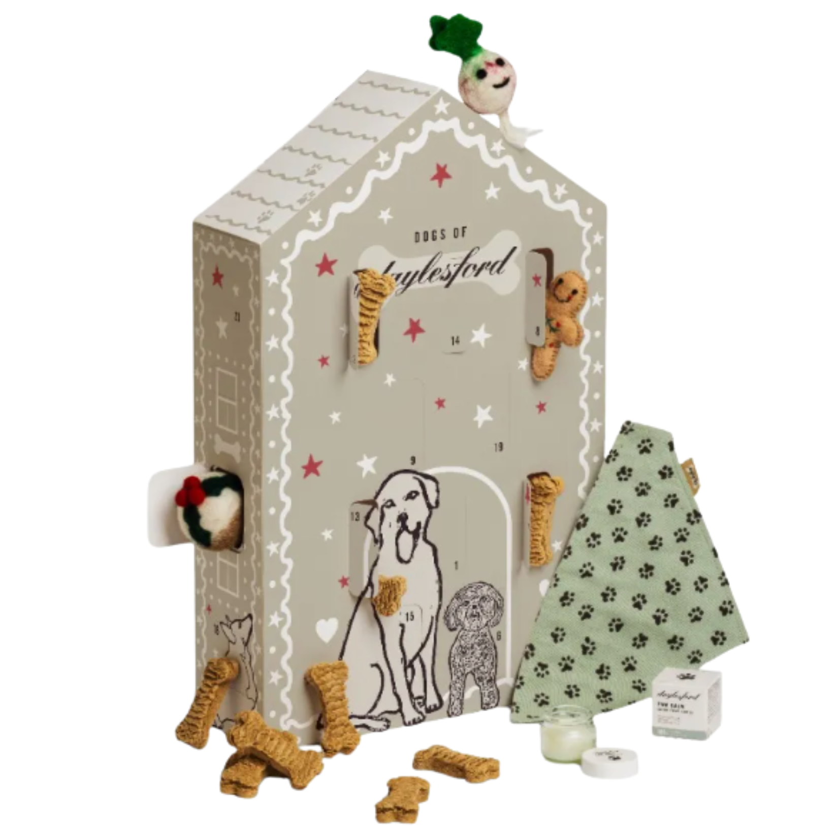 Daylesford Organic dog advent calendar shaped like a grey house, surrounded by bone-shaped treats, a green paw-print bandana, and a felt toy