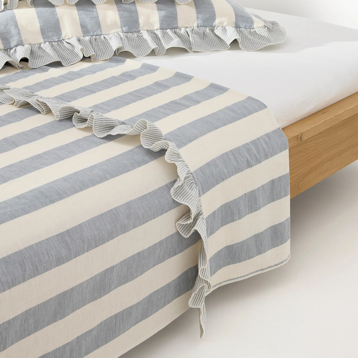 a blue and cream stripe fitted sheep with a ruffled trim