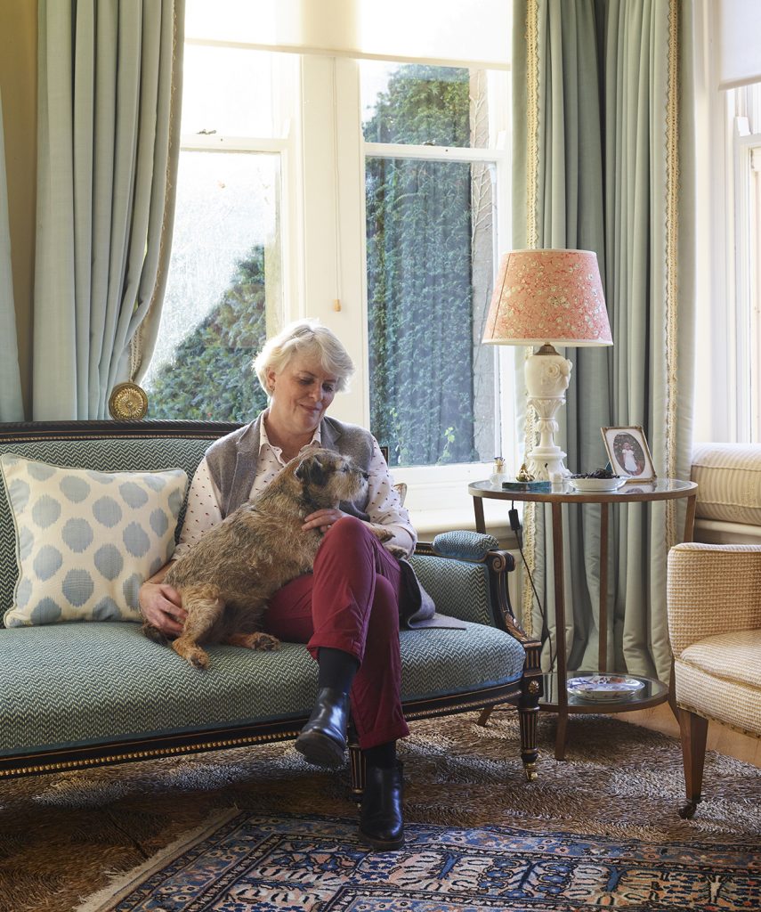 Sarah Ingleby in her home with her border terrier