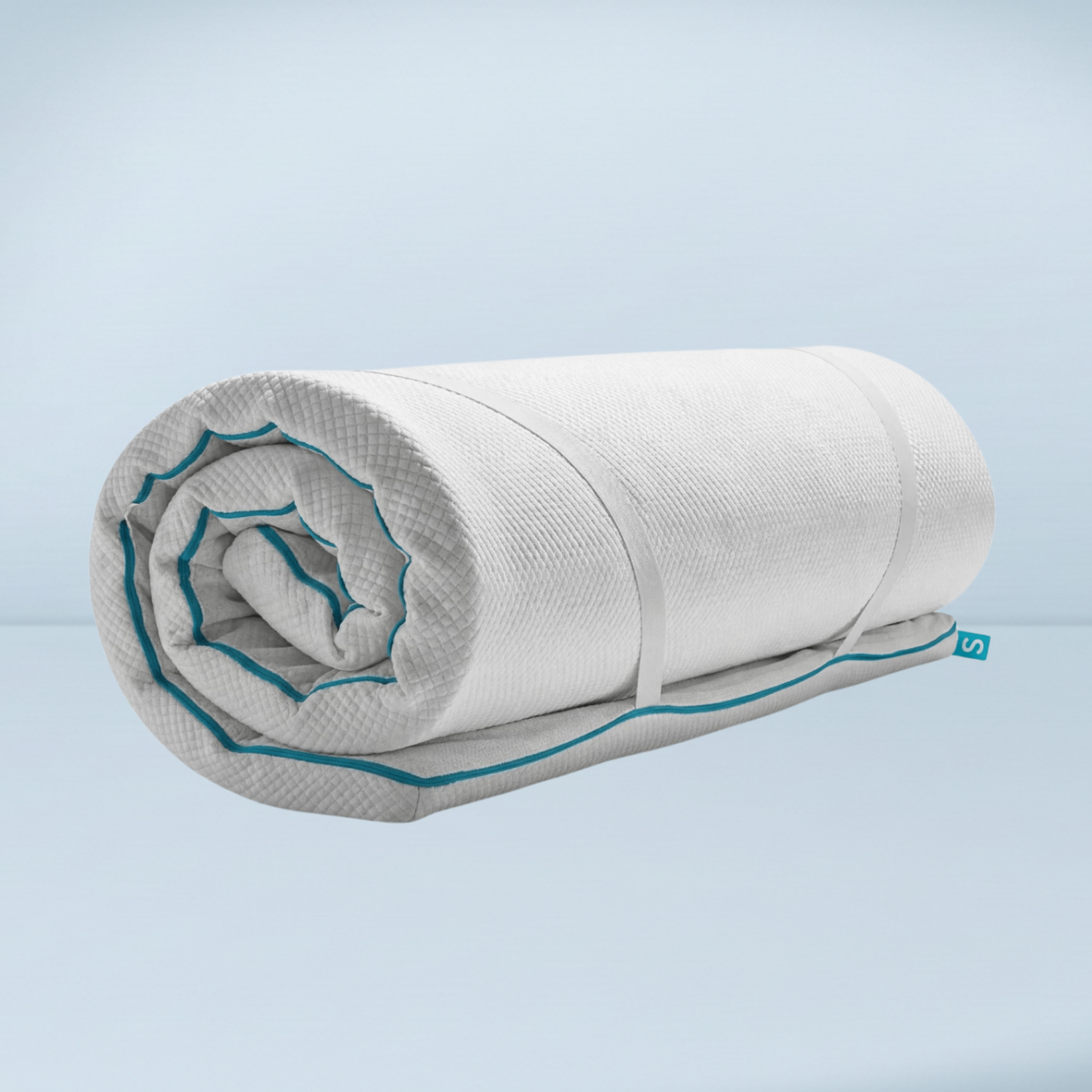 a rolled up mattress topper